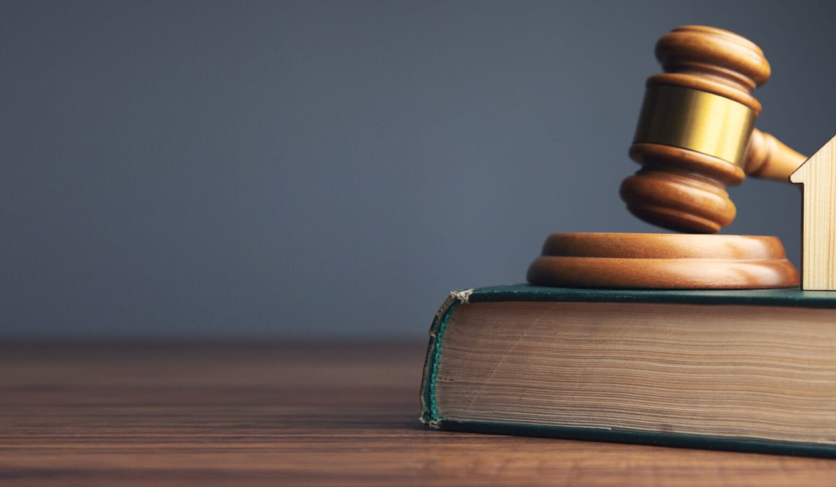 Judge auction and real estate concept. House model, gavel and law books