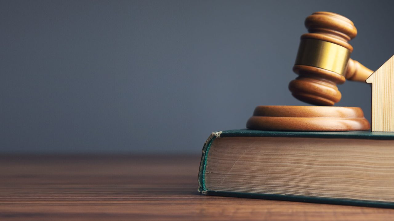 Judge auction and real estate concept. House model, gavel and law books